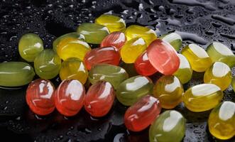 Lots of colorful candies. Multi-colored candies on a black background. Marmalade candies. photo