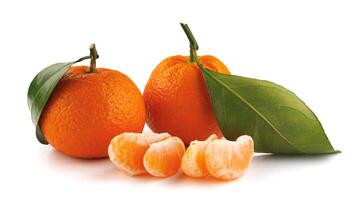 Two ripe tangerines and tangerine slices isolated on a white background. Organic tangerine with green leaf. Mandarin. photo