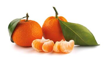 Two ripe tangerines and tangerine slices isolated on a white background. Organic tangerine with green leaf. Mandarin. photo