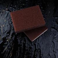 Melamine sponge on a black wet background. Beautiful drops of water around a melamine sponge. photo