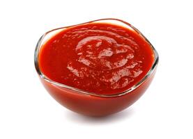 Ketchup in a glass cup isolated on a white background. Tomato sauce . photo