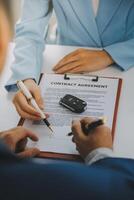 Insurance officers hand over the car keys after the tenant. have signed an auto insurance document or a lease or agreement document Buying or selling a new or used car with a car photo