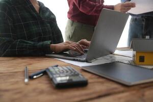 Diverse Team of Specialists Use Laptop on Construction Site. Real Estate Building Project with Engineer Investor and Businessman Checking Area, working on Civil Engineering, Discussing Strategy Plan photo