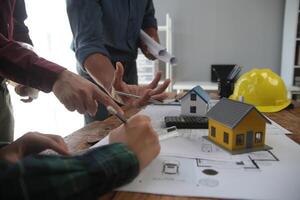 Diverse Team of Specialists Use Laptop on Construction Site. Real Estate Building Project with Engineer Investor and Businessman Checking Area, working on Civil Engineering, Discussing Strategy Plan photo