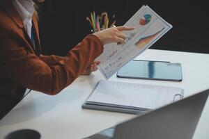 Woman sitting at desk and working at computer hands close up photo