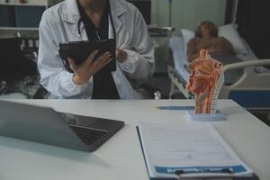 Female doctor explaining to patient results of model the process of patients. Diagnosis of diseases for Model Internal organ. photo