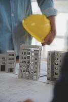 Construction and structure concept of Engineer or architect meeting for project working with partner and engineering tools on model building and blueprint in working site, contract for both companies. photo