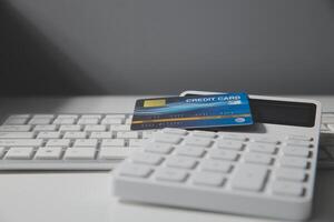 Calculator on a dark background, plastic cards and banknotes photo