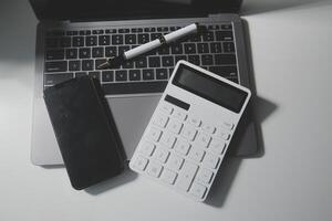 Office leather desk table with calculator and pen. Top view with copy space photo