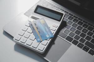 Calculator on a dark background, plastic cards and banknotes photo