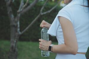 Young woman drinking protein shake outdoors photo