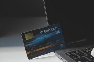 Calculator on a dark background, plastic cards and banknotes photo