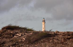 Arid Rugged Landscape with California Lighthouse in the Background photo