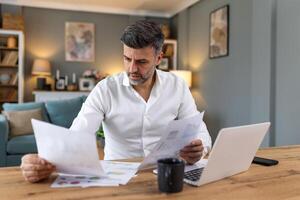 Business professionals. Business man analyzing data using computer while spending time in the office. Young grinning professional man in office. Graphs and charts photo