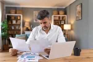 Business professionals. Business man analyzing data using computer while spending time in the office. Young grinning professional man in office. Graphs and charts photo