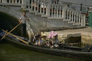 VENICE ITALY 25 MARCH 2019 Gondola in Venice with people on board photo