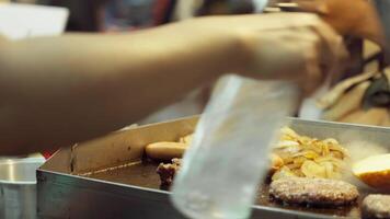 Chef cooking sausage and beef patty video