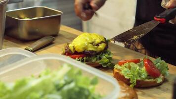 Chef putting meat burger patty on burger bun video