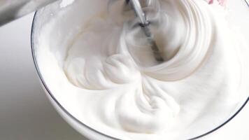 electric mixer whipping egg whites for cream, slow motion video