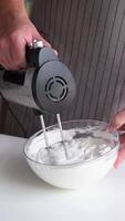 man using electric mixer whipping eggs for cream video