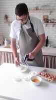 man using electric mixer whipping eggs for cream video