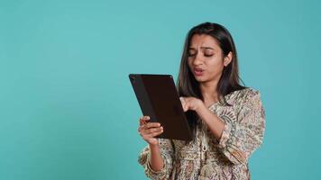 Woman trying to do purchases, frustrated with error received while adding payment method on website, studio background. Upset person unable to do internet shopping, getting card rejected, camera A video
