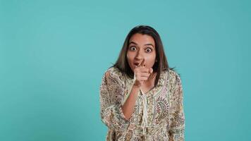 Irked indian woman fighting with boyfriend, doing scolding gesturing, isolated over studio background. Outraged wife arguing with husband during conversation, doing angry hand gestures, camera A video