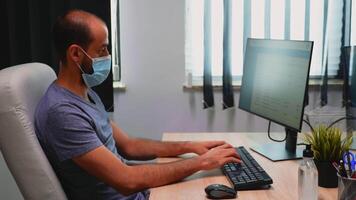 Freelancer typing on computer and cleaning hands with alcohol. Entrepreneur working in new normal office workplace in company disinfecting hands using antibacterian gel against corona virus. video