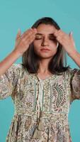 Vertical Woman covering eyes, ears and mouth, imitating three wise monkeys. Indian person doing don t see, don t hear and don t speak hand gesturing concept, studio background, camera A video