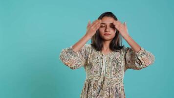 Woman covering eyes, ears and mouth, imitating three wise monkeys. Indian person doing don t see, don t hear and don t speak hand gesturing concept, studio background, camera A video