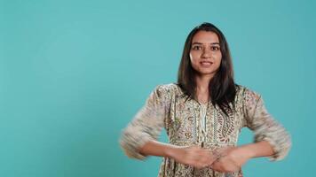 Happy indian person having fun, dancing on rhythm, enjoying leisure time. Cheerful woman entertaining herself doing funky movements, isolated over studio background, camera A video