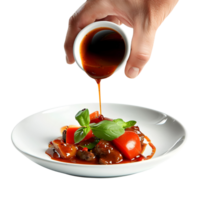 a hand pouring sauce onto a dish png