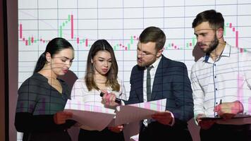 Group of businesspersons meeting in the office with stock market chart on background. Business and technology concept. Financial technology. Fintech video