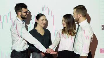 Corporate business team people group stacks hands together in pile with cryptocurrency chart on background. Leadership and teamwork spirit concept video