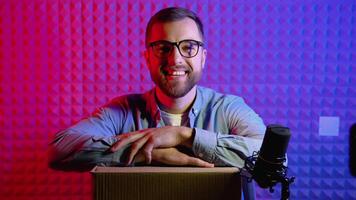 Portrait of a blogger with a box in a home studio video