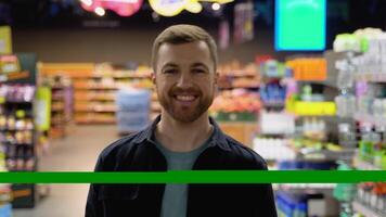 un hombre camina a tienda de comestibles supermercado y elegir el Derecha producto video