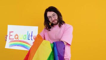 Young transsexual transgender man holding paper with equality message. Doubt concept video