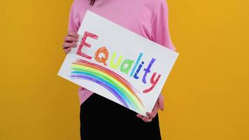 Gay caucasian man holding a protest sign during a LGBT pride parade. Equality concept video