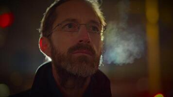 Young Man with Glasses Watching Light Show in the City at Night video