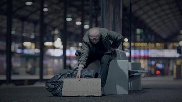Elderly Homeless Man Suffering from Poverty Looking for Help at Train Station video