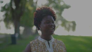 Happy Young African Woman in Summer Dress Looking at Park Trees video