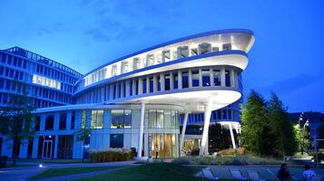 Pattern of office buildings windows illuminated at night. Glass architecture ,corporate building at night - business concept. photo