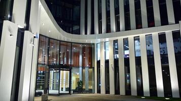 Pattern of office buildings windows illuminated at night. Glass architecture ,corporate building at night - business concept. photo