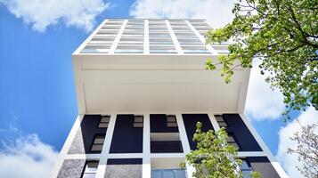 Modern apartment buildings on a sunny day with a blue sky. Facade of a modern apartment building. Glass surface with sunlight. photo