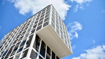 Modern apartment buildings on a sunny day with a blue sky. Facade of a modern apartment building. Glass surface with sunlight. photo