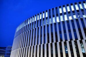 Pattern of office buildings windows illuminated at night. Glass architecture ,corporate building at night - business concept. photo