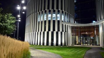 Pattern of office buildings windows illuminated at night. Glass architecture ,corporate building at night - business concept. photo