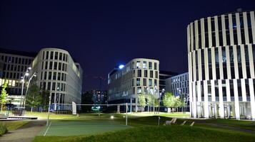 Pattern of office buildings windows illuminated at night. Glass architecture ,corporate building at night - business concept. photo