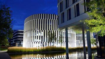 Pattern of office buildings windows illuminated at night. Glass architecture ,corporate building at night - business concept. photo