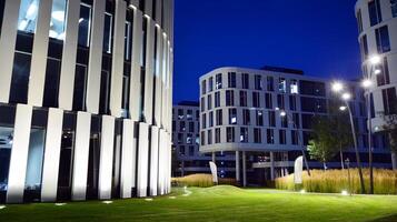 Pattern of office buildings windows illuminated at night. Glass architecture ,corporate building at night - business concept. photo